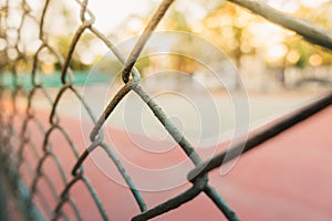 Image for background of tennis and basketball court behind grille