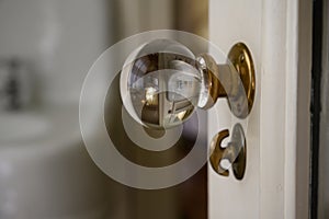 Image of bathroom though glass doorknob