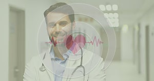 Image of beating heart and heartbeat symbol over smiling male doctor with stethoscope