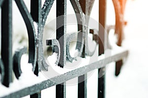 Image of a Beautiful decorative cast iron wrought iron fence with artistic forging. The metal fence is close