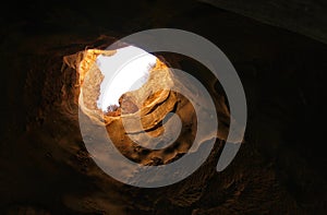 image of beautiful golden light through the cave entrance photo