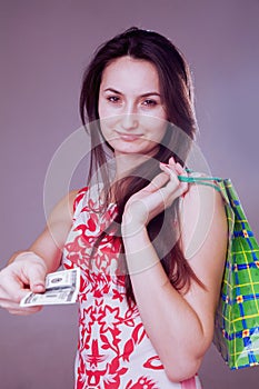 Image of a beautiful shocked happy woman with shopping bag