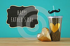 Image of black cup with golden heart. Father`s day concept.