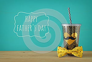 Image of black cup with golden heart. Father`s day concept.