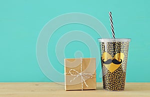 Image of black cup with golden heart. Father`s day concept.