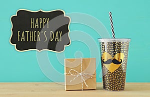 Image of black cup with golden heart. Father`s day concept.