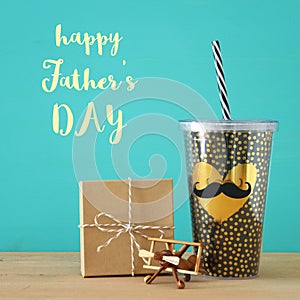 Image of black cup with golden heart. Father`s day concept.