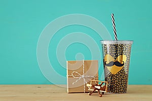Image of black cup with golden heart. Father`s day concept.