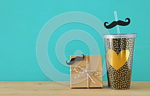 Image of black cup with golden heart. Father`s day concept.