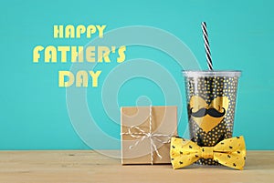 Image of black cup with golden heart. Father`s day concept.