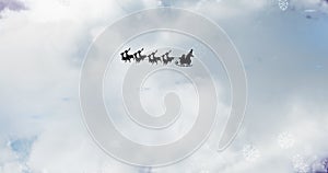 Image of black silhouette of santa claus in sleigh being pulled by reindeer and winter christmas