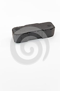 image with block of brown coal isolated on a white surface