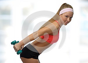 Image of blonde smiling woman with barbell in hand