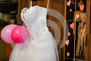 Image of the bodice of a weeding dress on a hanger photo