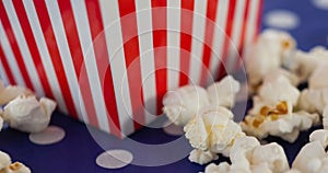 Image of box of popcorn over white spots