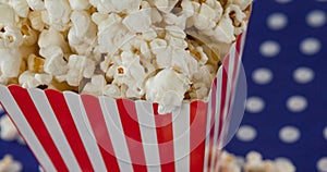 Image of box of popcorn over white spots