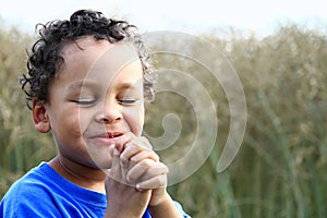 little boy praying to God stock photo