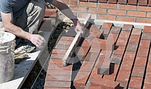 Brick Mason Laying A Sidewalk