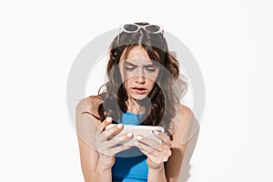 Image of brooding beautiful woman using cellphone and looking aside