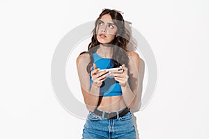 Image of brooding beautiful woman using cellphone and looking upward