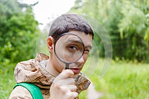 Image of brunet biologist with magnifying glass