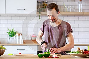 Image of brunet cooking vegetables on table