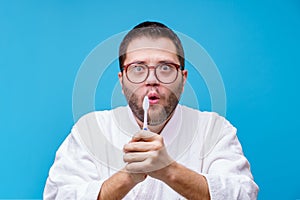 Image of brunet man with toothbrush in his hands