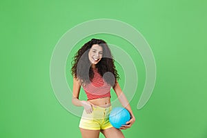 Image of brunette woman 20s wearing summer clothes smiling and holding volley ball