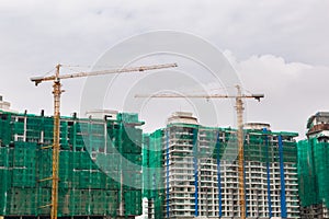 Image of a building in progress with security net around it. High building