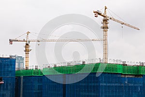 Image of a building in progress with security net around it. High building