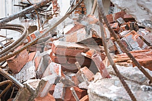 Image of a building under demolition. Concrete, bricks and steel beams.