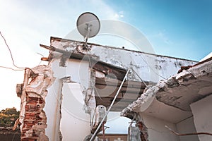 Image of a building under demolition. Concrete, bricks and steel beams.