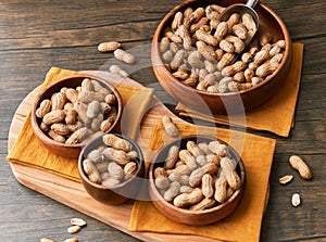 Image of bunch of peanuts in a bowl on a wooden table