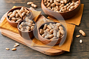 Image of bunch of peanuts in a bowl on a wooden table