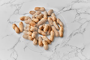 Image of bunch of peanuts on a marble table