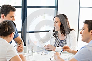 Image of business partners discussing documents and ideas