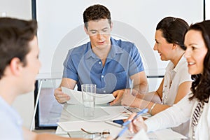 Image of business partners discussing documents and ideas