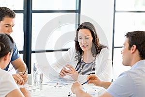 Image of business partners discussing documents and ideas