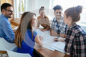 Image of business partners discussing documents and ideas