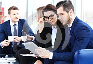 Image of business partners discussing documents and ideas