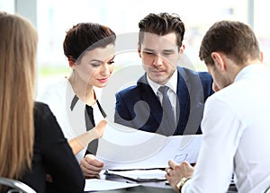 Image of business partners discussing documents and ideas