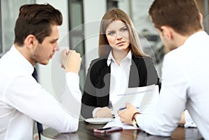 Image of business partners discussing documents and ideas