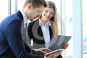 Image of business partners discussing documents and ideas