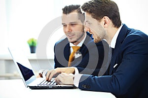 Image of business partners discussing documents and ideas