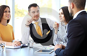 Image of business partners discussing documents and ideas