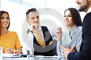 Image of business partners discussing documents and ideas