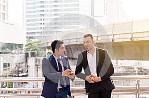 Image of businessman talking and consult while standing together