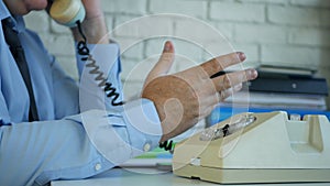 Image with a Businessman Talking on Telephone and Gesticulate