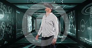Image of businessman wearing vr headset over screens with medical data processing