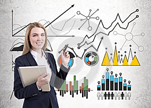 Image of businesswoman in grey suit drawing graph